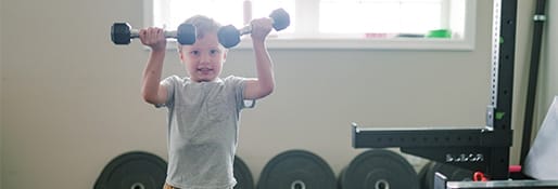 kid lifting weights at the gym